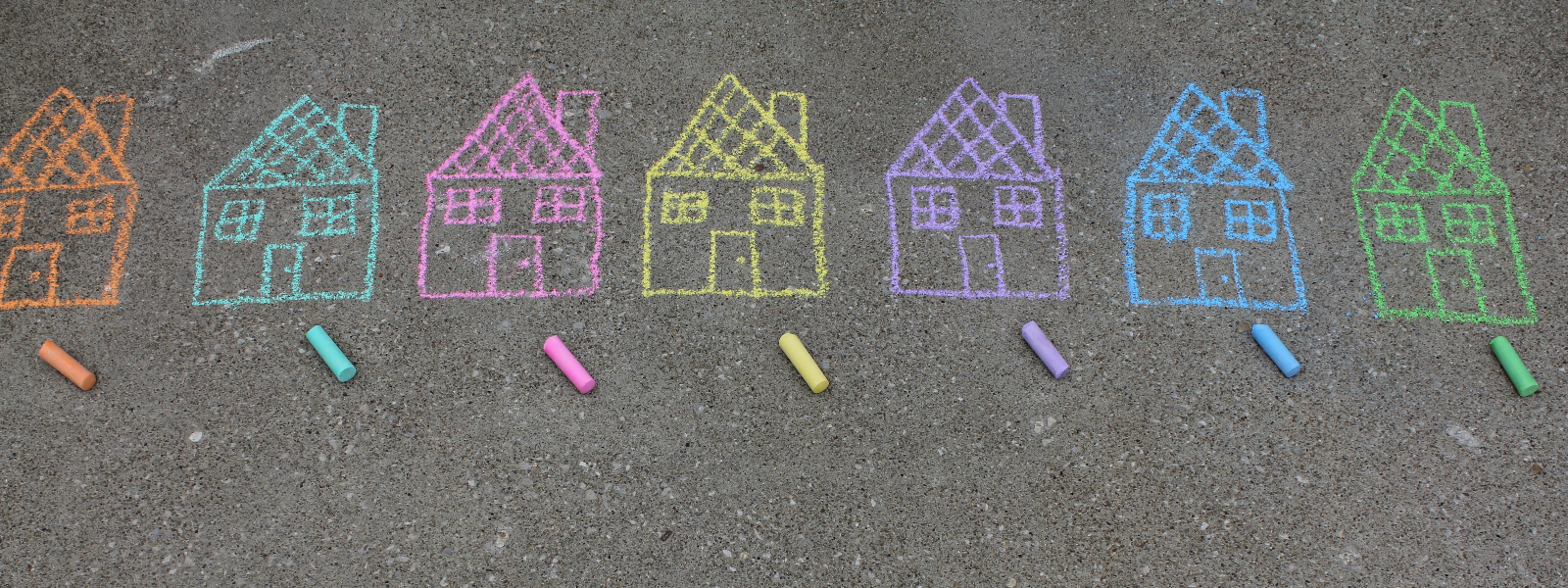 A row of colorful chalk houses, drawn on pavement.