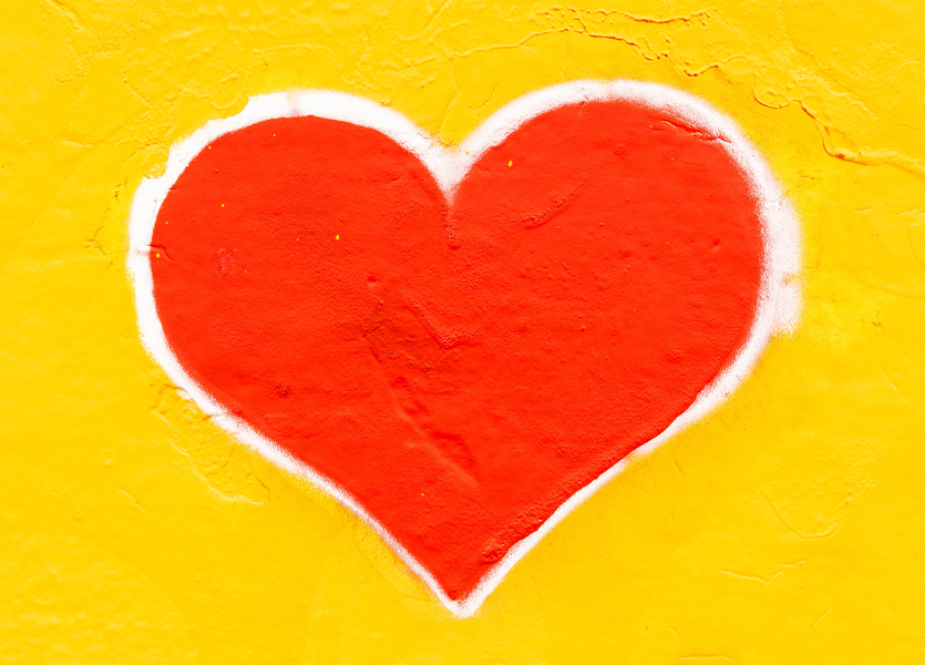 Red heart on yellow background. 