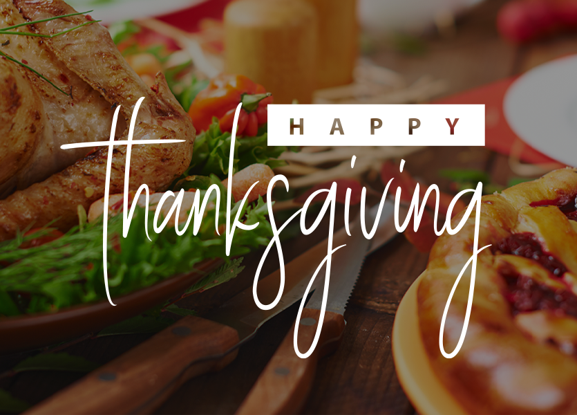 A close-up of a Thanksgiving meal. Text reads: Happy Thanksgiving. 