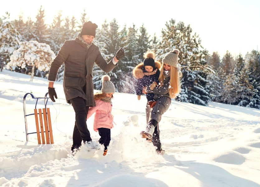 A family playing in the winter snow. 