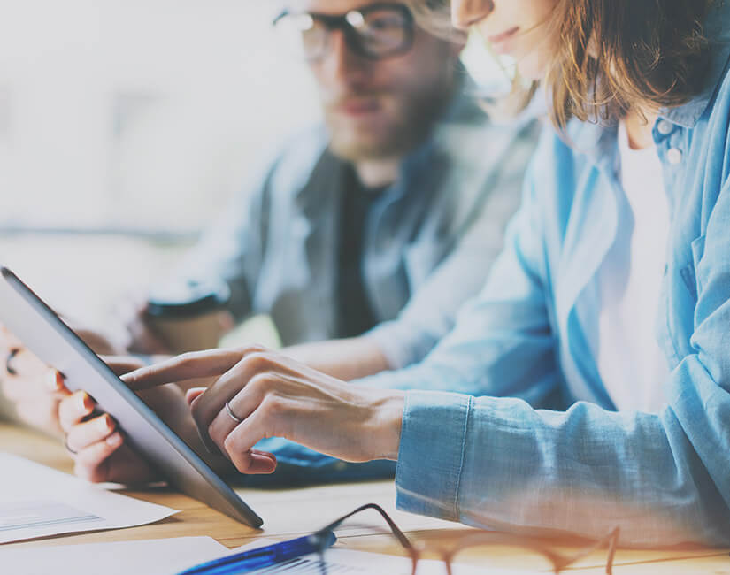 Woman and man looking at tablet