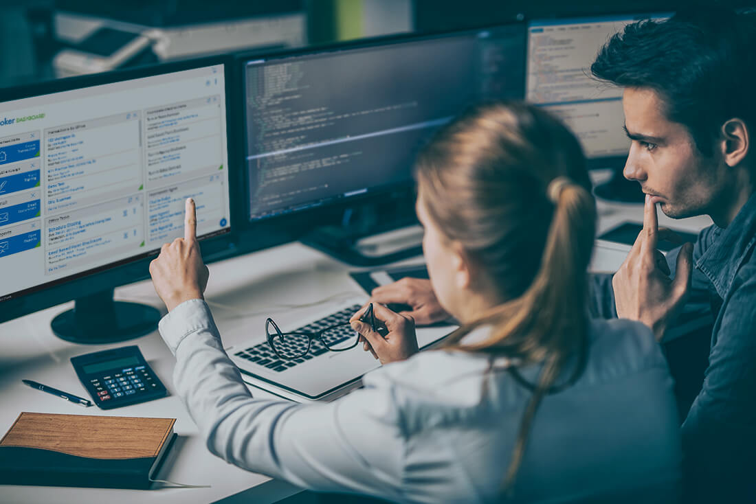 Young woman and man looking at computer screen